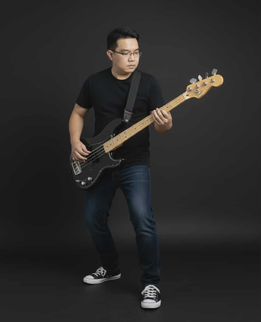 aOfztiMus Prime playing bass guitar on stage